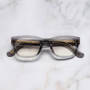 An image of the 0868 Kingsman Optical Square Glasses in Smoke Quartz frame frontal view with arms closed marble background