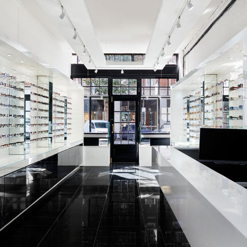 Image of inside the Spitalfields Store. The image shows the shelves of glasses on either side, and the till point.