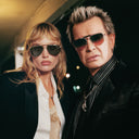 An image of Billy Idol wearing the Cutler and Gross The Great Frog Capri Rectangular Sunglasses in Silver/Green frame.