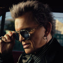 An image of Billy Idol wearing the Cutler and Gross The Great Frog Limited-Edition Triumph Aviator Sunglasses in Silver/Olive frame.