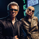 An image of Billy Idol wearing The Great Frog Ganton Navigator Titanium Sunglasses in Gun Metal/Silver.
