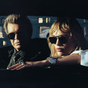 An image of Billy Idol wearing the Cutler and Gross The Great Frog Capri Rectangular Sunglasses in Gun Metal/Black frame.