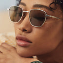 Close up image of female model wearing the 
Breitling Léman 0001 Square Sunglasses in Dark Grey