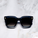 An image of the Breitling Marisol 0005 Square Sunglasses in Deep Blue Crystal frame frontal view with arms closed marble background 