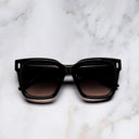 An image of the Breitling Marisol 0005 Square Sunglasses in Black frame frontal view with arms closed marble background 