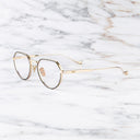 An image of the Pelham 1430 Round Opticals in Black/Gold frame side view with arms open marble background