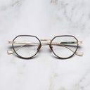 An image of the Pelham 1430 Round Opticals in Black/Gold frame frontal view with arms closed marble background