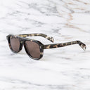 An image of the GR14 Aviator Sunglasses in Grey Havana frame side view with arms open marble background