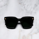 An image of the Breitling Marisol 0005 Square Sunglasses in 18K Red Gold frame frontal view with arms closed marble background 