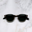 An image of the Breitling Biarritz 0003 Round Sunglasses in 18K Red Gold frame frontal view with arms closed marble background 