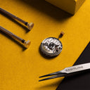 Close up image of the inside of a watch and a tweezer. 
