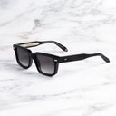 An image of the Breitling Cloudbreak 0004 Rectangle Sunglasses in Black frame side view with arms open marble background