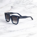 An image of the Breitling Marisol 0005 Square Sunglasses in Deep Blue Crystal frame side view with arms open marble background