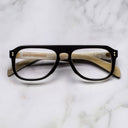 An image of the Cutler and Gross 0822V2 Aviator Horn Optical in Deep Black/Cream Buffalo Horn frame frontal view with arms closed marble background