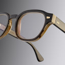 An image of the Cutler and Gross 9290 Round Horn Optical in Smoke Brown/Cream Buffalo Horn frame detail close up of right lens and temple