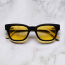 An image of the Cutler and Gross 0772 Square Horn Sunglass in Deep Matte Black/Cream Buffalo Horn frame frontal view with arms closed marble background