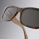 An image of the Cutler and Gross 1214 Rectangular Horn Sunglass in Speckled Brown Buffalo Horn frame detail close up from right side view