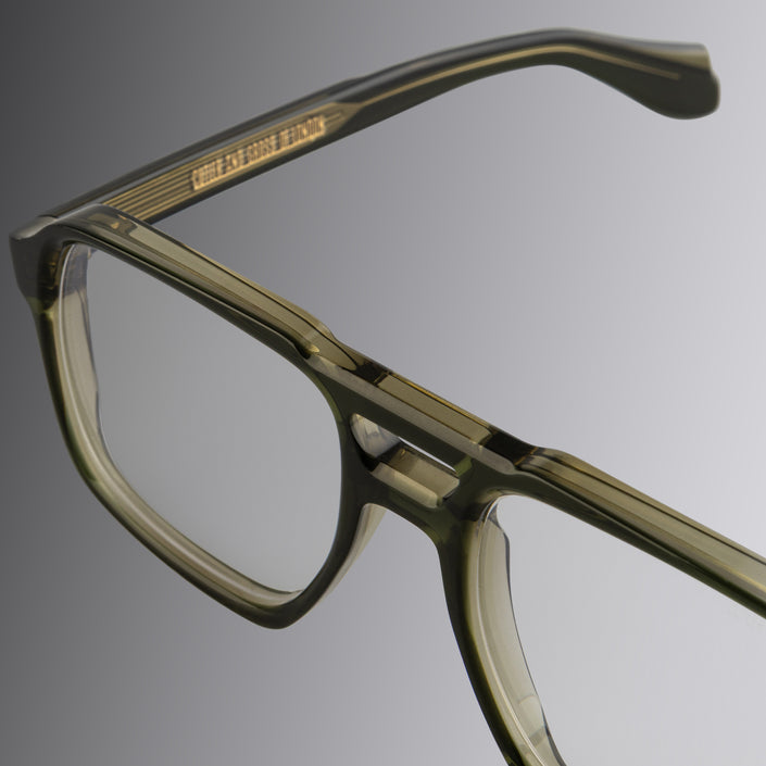 An image of the 1394 Aviator Optical in Olive green frame detail close up of left lens and temple, also featuring Cutler and Gross logo in gold  placed inside the temple