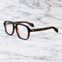 An image of the 1394 Aviator Optical in Dark Turtle frame side view with arms open marble background
