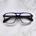 An image of the 1394 Aviator Optical in Classic Navy Blue frame frontal view with arms closed marble background