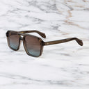 An image of the 1394 Aviator Sunglasses in Brown Crystal frame side view with arms open marble background
