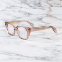 An image of the 1411 Cat Eye Optical in Dusk frame side view with arms open marble background