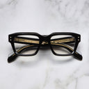 An image of the 1432 Square Optical in Black frame frontal view with arms closed marble background