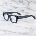 An image of the 1432 Square Optical in Deep Blue frame side view with arms open marble background