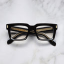 An image of the 9386 Square Optical in Black frame frontal view with arms closed marble background