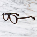 An image of the 9782 Aviator Optical in Dark Turtle frame side view with arms open marble background