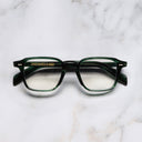 An image of the GR07 Square Optical Glasses in Striped Dark Green frame frontal view with arms closed marble background 