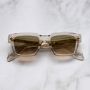 An image of the 1432 Square Sunglasses in Sand Crystal frame frontal view with arms closed marble background