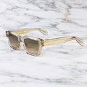 An image of the 1432 Square Sunglasses in Sand Crystal frame side view with arms open marble background
