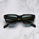 An image of the 1432 Square Sunglasses in Black frame frontal view with arms closed marble background