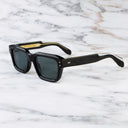 An image of the 1432 Square Sunglasses in Black frame side view with arms open marble background