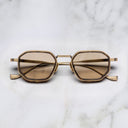 An image of the Cutler and Gross Carlyle 1437 in Antique Gold/Havana frame frontal view with arms closed in marble background.