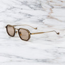 An image of the Cutler and Gross Carlyle 1437 in Antique Gold/Havana frame side view with arms open marble background.