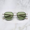 An image of the Cutler and Gross Carlyle 1437 in Antique Silver/Green frame frontal view with arms closed in marble background.