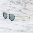 An image of the Cutler and Gross 1438 in Silver/Gold/Havana frame side view with arms open in marble background.