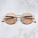 An image of the Cutler and Gross Brompton 1438 in Pink Gold/White Horn  frame frontal view with arms closed in marble background.