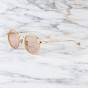 An image of the Cutler and Gross Brompton 1438 in Pink Gold/White Horn  frame side view with arms open marble background.