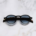 An image of the GR08 Round Sunglasses in Black on Havana frame frontal view with arms closed marble background 