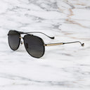An image of the Sloane 1423 Aviator Sunglasses in Black/Gold frame side view with arms open marble background