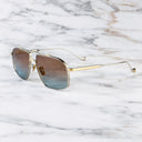 An image of the Kensington 1424 Aviator Sunglasses in Silver/Gold frame side view with arms open marble background