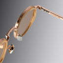An image of the Cutler and Gross Brompton 1438 in Pink Gold/White Horn with arms open frame detail close up of right lens and right temple in grey background.
