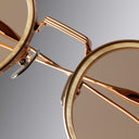 An image of the Cutler and Gross Brompton 1438 in Pink Gold/White Horn close up of nosepads and lens in grey background.