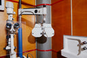 An Image of Optical equipment in a clinical setting with wooden walls.