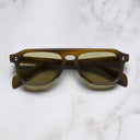 An image of the GR14 Aviator Sunglasses in Mustard Horn frame frontal view with arms closed marble background