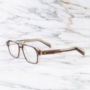 An image of the GR15 Aviator Opticals in Grey on Granny Chic frame side view with arms open marble background