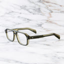 An image of the GR15 Aviator Opticals in Multi Olive frame side view with arms open marble background